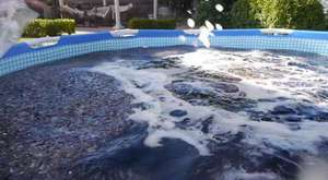 WTF? This Guy Takes A Bath In A Giant 1,500 Gallon Coca-Cola Swimming Pool!