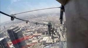 Watch A Brave Woman Test Out The Glass Slide Suspended 1,000 Feet Above Downtown Los Angeles